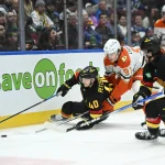 Mar 5, 2025; Vancouver, British Columbia, CAN; Anaheim Ducks forward Leo Carlsson (91) checks Vancouver Canucks forward Elias Pettersson (40) at Rogers Arena during the first period. Mandatory Credit: Simon Fearn-Imagn Images