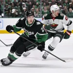 Apr 20, 2026; Dallas, Texas, USA; Dallas Stars left wing Jason Robertson (21) and Minnesota Wild center Michael McCarron (47) look for the puck during the game between the Stars and the Wild in game two of the first round of the 2026 Stanley Cup Playoffs at American Airlines Center.