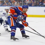 Feb 3, 2026; Edmonton, Alberta, CAN; Edmonton Oilers forward Connor McDavid (97) protects the puck from Toronto Maple Leafs defensemen Oliver Elman-Larsson (95) during the first period at Rogers Place.
