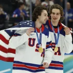 Feb 22, 2026; Milan, Italy; Quinn Hughes (43) of the United States and Jack Hughes (86) of the United States celebrate after defeating Canada in the men's ice hockey gold medal game during the Milano Cortina 2026 Olympic Winter Games at Milano Santagiulia Ice Hockey Arena.