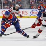 Jan 20, 2026; Edmonton, Alberta, CAN; New Jersey Devils defensemen Simon Nemec (17) knocks the puck away from Edmonton Oilers forward Vasily Podkolzin (92) during the third period at Rogers Place.