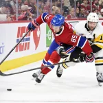 Dec 20, 2025; Montreal, Quebec, CAN; Montreal Canadiens forward Alexandre Texier (85) plays the puck and Pittsburgh Penguins forward Bryan Rust (17) defends during the third period at the Bell Centre.