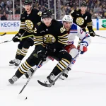 Sep 24, 2023; Boston, Massachusetts, USA; Boston Bruins defenseman Reilly Walsh (92) against New York Rangers center Jonny Brodzinski (22) during the second period at TD Garden. Mandatory Credit: Eric Canha-Imagn Images