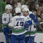 Mar 25, 2023; Dallas, Texas, USA; Vancouver Canucks center Dakota Joshua (81) and defenseman Kyle Burroughs (44) and center Nils Aman (88) and defenseman Quinn Hughes (43) celebrate after Joshua scores a shorthanded goal against Dallas Stars goaltender Matt Murray (32) during the first period at the American Airlines Center. Mandatory Credit: Jerome Miron-Imagn Images