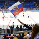 Feb 11, 2014; Sochi, RUSSIA; A fan waves a Russian flag in a preliminary round women\'s ice hockey game between Russia and Japan during the Sochi 2014 Olympic Winter Games at Shayba Arena. Mandatory Credit: Scott Rovak-Imagn Images