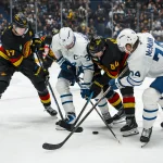 Jan 31, 2026; Vancouver, British Columbia, CAN; Vancouver Canucks defenseman Tyler Myers (57) and forward David Kampf (64) battle with Toronto Maple Leafs forward Auston Matthews (34) and forward Bobby McMann (74) in the third period at Rogers Arena. Mandatory Credit: Bob Frid-Imagn Images