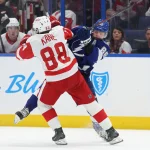 Apr 11, 2025; Tampa, Florida, USA; Tampa Bay Lightning right wing Nikita Kucherov (86) and Detroit Red Wings right wing Patrick Kane (88) fight to control the puck during the third period at Amalie Arena.
