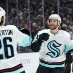 Feb 4, 2026; Los Angeles, California, USA; Seattle Kraken center Shane Wright (51) celebrates with center Ryan Winterton (26) after scoring a goal during the first period against the Los Angeles Kings at Crypto.com Arena.