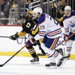 Feb 23, 2023; Pittsburgh, Pennsylvania, USA; Edmonton Oilers center Leon Draisaitl (29) skates with the puck against Pittsburgh Penguins right wing Bryan Rust (17) during the first period at PPG Paints Arena.