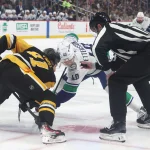 Oct 21, 2025; Pittsburgh, Pennsylvania, USA; Pittsburgh Penguins center Ben Kindel (81) and Vancouver Canucks center Elias Pettersson (40) take a first period face-off at PPG Paints Arena.