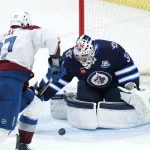 Mar 26, 2026; Winnipeg, Manitoba, CAN; Colorado Avalanche defenseman Brett Kulak (27) shoots on Winnipeg Jets goaltender Connor Hellebuyck (37) in the third period at Canada Life Centre.