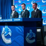 May 14, 2026; Vancouver, BC, Canada; Henrik Sedin and Daniel Sedin listen to Ryan Johnson speak during a press conference where the Vancouver Canucks name new senior management staff. Henrik Sedin and his twin brother Daniel Sedin have been appointed as co-presidents of hockey operations and Ryan Johnson is now the new general manager of the club at Rogers Arena.