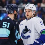 Feb 28, 2026; Seattle, Washington, USA; Vancouver Canucks center Teddy Blueger (53) and Seattle Kraken center Shane Wright (51) exchange words during the second period at Climate Pledge Arena.