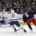 Dec 23, 2023; Columbus, Ohio, USA; Toronto Maple Leafs goalie Martin Jones (31) stops the shot from Columbus Blue Jackets defenseman Zach Werenski (8) during the third period at Nationwide Arena.