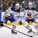 Mar 12, 2026; Dallas, Texas, USA; Edmonton Oilers center Connor McDavid (97) and center Ryan Nugent-Hopkins (93) skates against the Dallas Stars during the game between the Stars and the Oilers at the American Airlines Center.