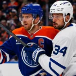 Feb 3, 2026; Edmonton, Alberta, CAN; Edmonton Oilers forward Connor McDavid (97) and Toronto Maple Leafs forward Auston Matthews (34) battle for position during the first period at Rogers Place.