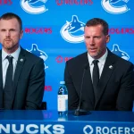 May 14, 2026; Vancouver, BC, Canada; Daniel Sedin listens to Ryan Johnson speak during a press conference where the Vancouver Canucks name new senior management staff. Henrik Sedin and his twin brother Daniel Sedin have been appointed as co-presidents of hockey operations and Ryan Johnson is now the new general manager of the club at Rogers Arena.
