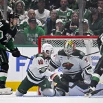 Apr 28, 2026; Dallas, Texas, USA; Dallas Stars left wing Jason Robertson (21) scores a goal past Minnesota Wild defenseman Jared Spurgeon (46) and goaltender Jesper Wallstedt (30) during the third period in game five of the first round of the 2026 Stanley Cup Playoffs at American Airlines Center.
