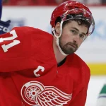 Feb 10, 2024; Detroit, Michigan, USA; Detroit Red Wings center Dylan Larkin (71) looks up from the ice after he is high sticked in the second period against the Vancouver Canucks at Little Caesars Arena.