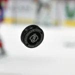 Apr 5, 2025; Montreal, Quebec, CAN; French logo on an NHL puck during the warmup period before the game between the Philadelphia Flyers and the Montreal Canadiens at the Bell Centre.