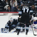 Apr 7, 2026; Salt Lake City, Utah, USA; Utah Mammoth goaltender Karel Vejmelka (70) covers up the puck against Edmonton Oilers center Colton Dach (34) during the first period at Delta Center. Mandatory Credit: Rob Gray-Imagn Images
