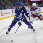 Mar 25, 2026; Toronto, Ontario, CAN; Toronto Maple Leafs forward William Nylander (88) goes to pass the puck as New York Rangers defenseman Braden Schneider (4) closes in during the third period at Scotiabank Arena.
