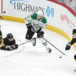 Mar 28, 2026; Pittsburgh, Pennsylvania, USA; Dallas Stars left wing Jason Robertson (21) moves the puck between Pittsburgh Penguins center Tommy Novak (18) and defenseman Parker Wotherspoon (28) during the third period at PPG Paints Arena.