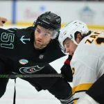 Jan 6, 2026; Seattle, Washington, USA; Seattle Kraken center Shane Wright (51) and Boston Bruins center Pavel Zacha (18) face-off during the second period at Climate Pledge Arena.