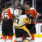 Apr 29, 2026; Philadelphia, Pennsylvania, USA; Philadelphia Flyers center Trevor Zegras (46) pushes Pittsburgh Penguins center Sidney Crosby (87) in overtime in game six of the first round of the 2026 Stanley Cup Playoffs at Xfinity Mobile Arena.