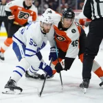 Nov 1, 2025; Philadelphia, Pennsylvania, USA; Toronto Maple Leafs center Nicolas Roy (55) and Philadelphia Flyers center Trevor Zegras (46) battle for a faceoff in the first period at Xfinity Mobile Arena.