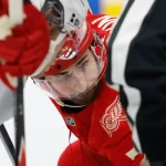 Apr 11, 2026; Detroit, Michigan, USA; New Jersey Devils center Jack Hughes (86) and Detroit Red Wings center Dylan Larkin (71) get set to face off in the second period at Little Caesars Arena.