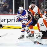 Feb 22, 2025; Philadelphia, Pennsylvania, USA; Edmonton Oilers center Connor McDavid (97) shoots the puck against Philadelphia Flyers defenseman Nick Seeler (24) in the second period at Wells Fargo Center.