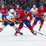 3 décembre 2024; Montréal, Québec, Canada; l'ailier droit des Canadiens de Montréal, Patrik Laine (92), joue la rondelle contre l'ailier gauche des Islanders de New York, Anders Lee (27), durant la troisième période au Centre Bell.