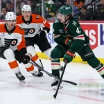Mar 12, 2026; Saint Paul, Minnesota, USA; Minnesota Wild defenseman Quinn Hughes (43) skates with the puck as Philadelphia Flyers defenseman Jamie Drysdale (9) defends during the second period at Grand Casino Arena