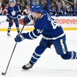 Mar 20, 2026; Toronto, Ontario, CAN; Toronto Maple Leafs defenseman Morgan Rielly (44) hits a slapshot against the Carolina Hurricanes in the first period at Scotiabank Arena.