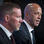 Jun 4, 2026; Vancouver, BC, CANADA; General manager Ryan Johnson listens to Manny Malhotra speak during press conference where the Vancouver Canucks introduce Malhotra as their new head coach during a press conference at Rogers Arena.