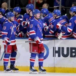 Mar 27, 2026; New York, New York, USA; New York Rangers left wing Alexis Lafreniere (13) celebrates his goal against the Chicago Blackhawks with teammates during the third period at Madison Square Garden.