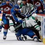 May 13, 2024; Denver, Colorado, USA; Colorado Avalanche center Andrew Cogliano (11) pushes Dallas Stars right wing Evgenii Dadonov (63) over defenseman Josh Manson (42) in the third period in game four of the second round of the 2024 Stanley Cup Playoffs at Ball Arena.