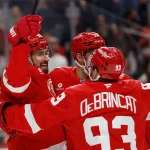 Mar 28, 2026; Detroit, Michigan, USA; Detroit Red Wings center Dylan Larkin (71) receives congratulations from teammates after scoring in the second period against the Philadelphia Flyers at Little Caesars Arena.