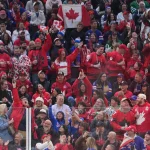 Feb 19, 2026; Milan, Italy; Canadian fans show their spirit in the women's ice hockey gold medal game against the United States during the Milano Cortina 2026 Olympic Winter Games at Milano Santagiulia Ice Hockey Arena.