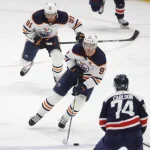 Feb 2, 2022; Washington, District of Columbia, USA; Edmonton Oilers center Connor McDavid (97) skates with the puck in front of Oilers left wing Evander Kane (91) as Washington Capitals defenseman John Carlson (74) defends during the third period at Capital One Arena.