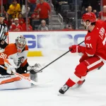 Mar 28, 2026; Detroit, Michigan, USA; Detroit Red Wings center Dylan Larkin (71) scores on Philadelphia Flyers goaltender Dan Vladar (80) in the second period at Little Caesars Arena.