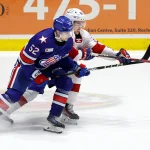 Rochester's Aleksandr Kisakov stick checks Laval's Sean Farrell.