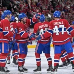 Apr 24, 2026; Montreal, Quebec, CAN; Montreal Canadiens defenseman Lane Hutson (48) celebrates with teammates after scoring the winning goal against the Tampa Bay Lightning during the overtime period in game three of the first round of the 2026 Stanley Cup Playoffs at the Bell Centre.