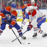 16 mars 2024; Edmonton, Alberta, Canada; L'attaquant des Oilers d'Edmonton, Connor McDavid (97), tente de contourner le défenseur des Canadiens de Montréal, Kaiden Guhle (21), avec la rondelle durant la première période au Rogers Place.