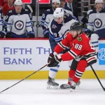 Jan 19, 2020; Chicago, Illinois, USA; Chicago Blackhawks right wing Patrick Kane (88) and Winnipeg Jets right wing Patrik Laine (29) fight for the puck during the first period at the United Center.