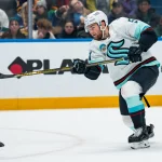 Jan 2, 2026; Vancouver, British Columbia, CAN; Seattle Kraken forward Shane Wright (51) shoots against the Vancouver Canucks in the first period at Rogers Arena.