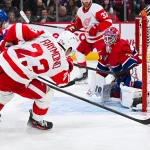 Dec 2, 2023; Montreal, Quebec, CAN; Montreal Canadiens goalie Jake Allen (34) makes a save against Detroit Red Wings left wing Lucas Raymond (23) during the second period at Bell Centre.