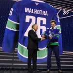 Jun 26, 2026; Buffalo, New York, USA; Caleb Malhotra reacts with NHL commissioner Gary Bettman after being selected with the third pick in the first round of the 2026 NHL Draft by the Vancouver Canucks at KeyBank Center.