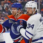 Feb 3, 2026; Edmonton, Alberta, CAN; Edmonton Oilers forward Connor McDavid (97) and Toronto Maple Leafs forward Auston Matthews (34) battle for position during the first period at Rogers Place.